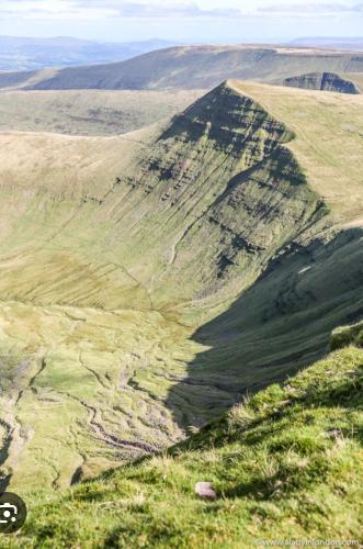 an aerial view of a mountain with grass at The Old Milking Parlour in Llandovery