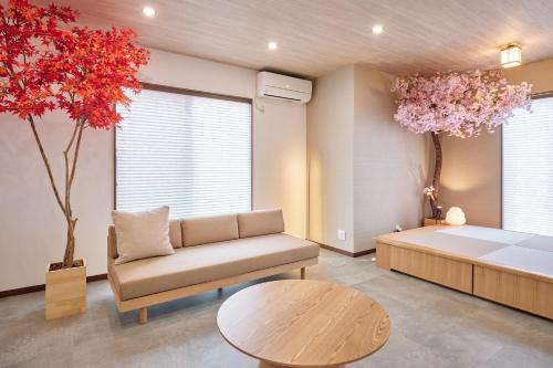 a bedroom with a bed and a couch and a table at SAKURA Haus in Fujinomiya