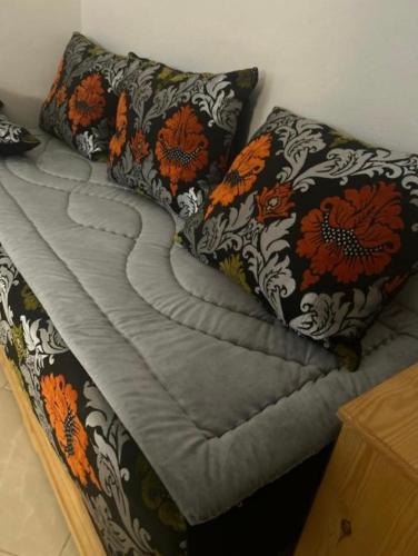 a bed with two pillows on top of it at Hoceima in Al Hoceïma