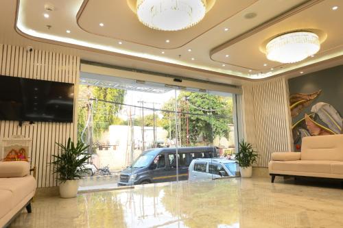 a lobby with a car parked in a garage at Hotel Kashi Crown in Varanasi