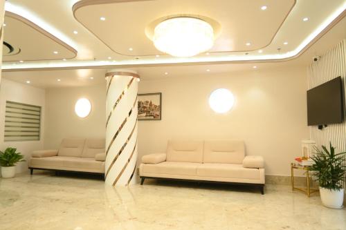 a waiting room with two couches and a christmas pole at Hotel Kashi Crown in Varanasi