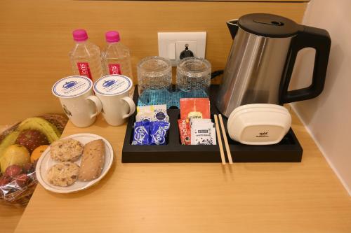 a tray with food and drinks on a table at Hotel Kashi Crown in Varanasi