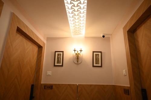 a hallway with a door and a light on the ceiling at Hotel Kashi Crown in Varanasi