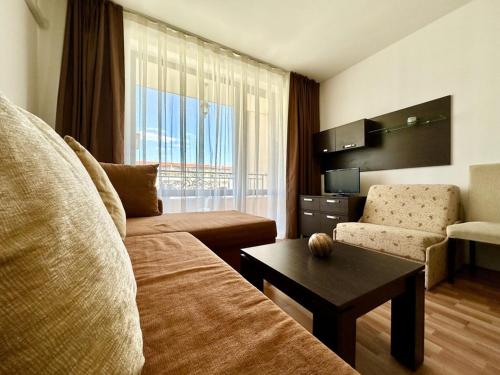 a living room with a couch and a coffee table at Menada Diamant Apartments in Sunny Beach