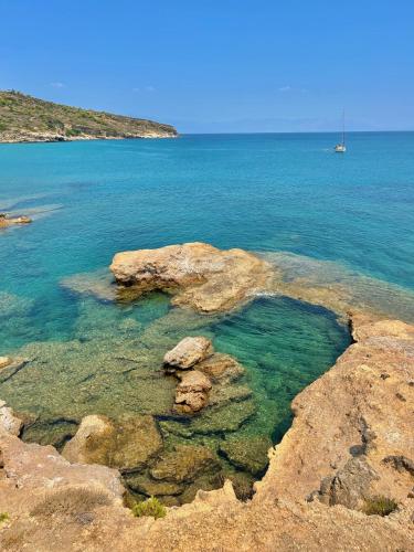a large body of water with a boat in the distance at Thalasson Beach House in Koroni