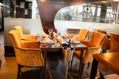 a dining room with a wooden table and chairs at Samarons Hotels in Tunis