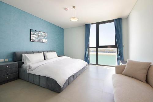 a bedroom with a large bed and a couch at Silk Valley - 4B near Al Hamriyah | private beach access in Sharjah