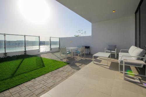 a living room with a patio with a table and chairs at Silk Valley - 4B near Al Hamriyah | private beach access in Sharjah