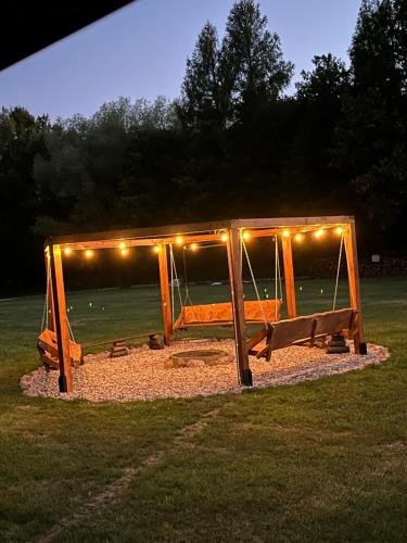 a playground with lights on it in a field at Agroturystyka na Cisowym in Cisowe