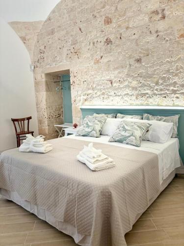 a bedroom with a large bed with towels on it at ALLE TERRAZZE di Castellana Grotte in Castellana Grotte