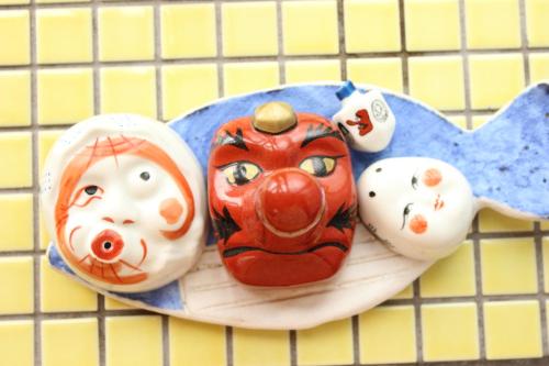 a plate with puppets on top at Katsuo Guest House in Kochi