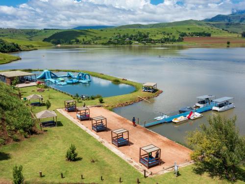an island in the middle of a lake with boats at Cayley Mountain Resort in Champagne Valley