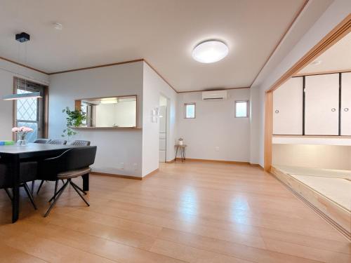 a living room with a table and a dining room at Tsukisucho, 4 bedrooms, 1 Japanese style room, 4LDK, Namba, Nihonbashi, Tsutenkaku house, free parking, elevator in Osaka