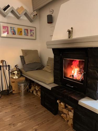 a living room with a fireplace and a couch at Kamocsay Vendégház in Mór