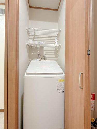 a bathroom with a sink and a refrigerator at Tsukisucho, 4 bedrooms, 1 Japanese style room, 4LDK, Namba, Nihonbashi, Tsutenkaku house, free parking, elevator in Osaka