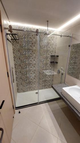 a bathroom with a shower and a sink at Maison 7 New Cairo in Cairo