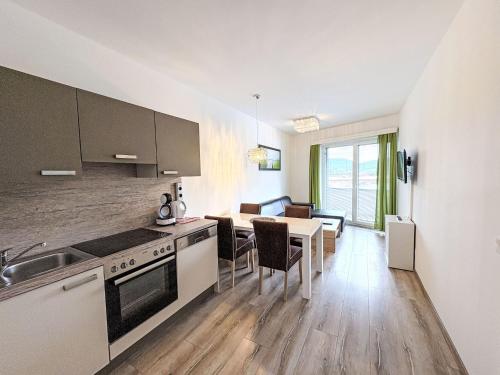 a kitchen with a table and a dining room at Apartment Mentenwirt Alp Lungau by Interhome in Sankt Michael im Lungau