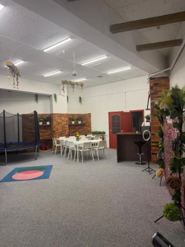 a room with a table and chairs and a room with at WooW kids club in Rīga