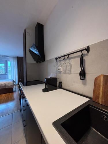 a kitchen with a sink and a counter top at Apartman MINI in Doboj
