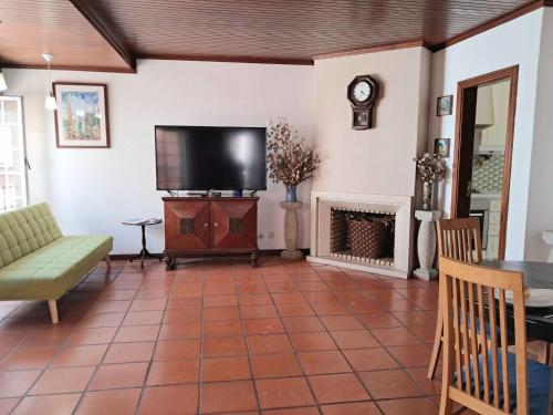 a living room with a tv and a fireplace at Apartment Dom Carlos by Interhome in Cascais