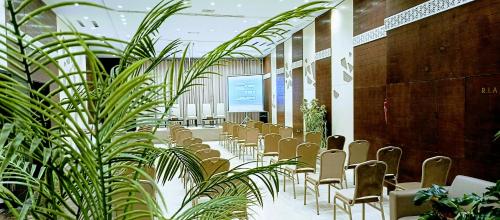a row of chairs in a room with plants at Samarons Hotels in Tunis