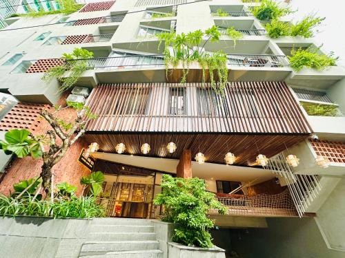 an external view of a building with plants at 405MSNK Maison Luxe Twin Studio l Balcony & Kitchen in Can Tho