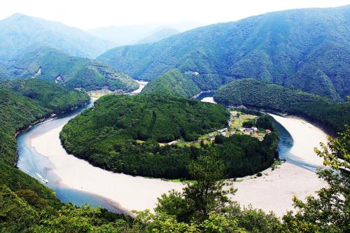 an aerial view of a river in the mountains at Iruka Onsen Hotel Seiryuusou in Kumano