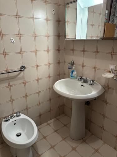 a bathroom with a sink and a toilet at Del Casel Apartment in San Zeno di Montagna