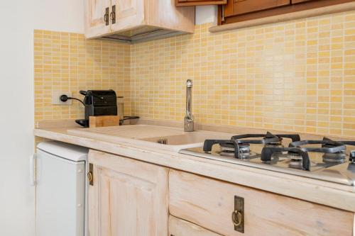 a kitchen with a sink and a stove at Trullimania in Alberobello