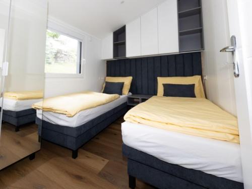 two twin beds in a room with a window at Holiday Home Karoline by Interhome in Aschach an der Steyr