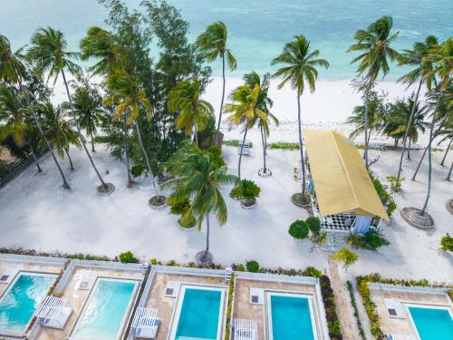 an aerial view of a resort with palm trees and the beach at ZAN Orient Beach Hotel in Bwejuu