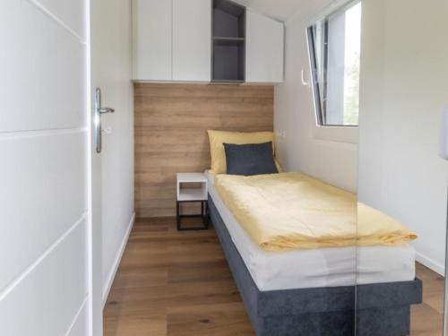 a small bedroom with a bed and a window at Holiday Home Karoline by Interhome in Aschach an der Steyr