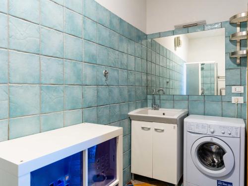 a bathroom with a washing machine and a sink at Apartment La Terrazza by Interhome in Cipressa