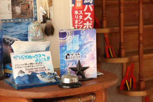 a wooden table with some items on it at Katsuo Guest House in Kochi