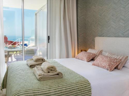 a bedroom with a bed with towels on it at Apartment Bayviewhills Amazing Spa & Padel by Interhome in Torrox Costa