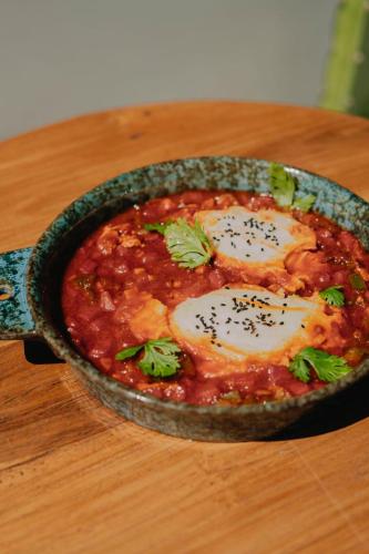 a pan of food with two eggs on a table at Sky Breeze in Unawatuna
