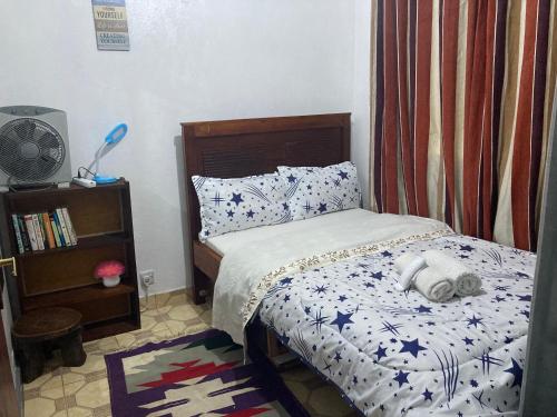 a bedroom with a bed with a stuffed animal on it at Ronnie's rustic home in Nairobi