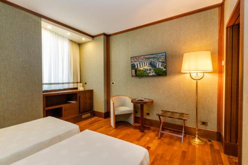 Postel nebo postele na pokoji v ubytování Grand Hotel Duca D'Este