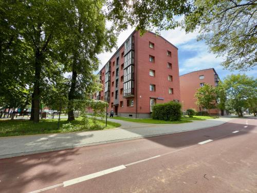 a red brick building on the side of a street at Welcome City Centre Apartments in Klaipėda