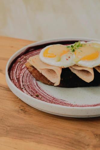 a plate with an egg on top of a piece of bread at Sky Breeze in Unawatuna