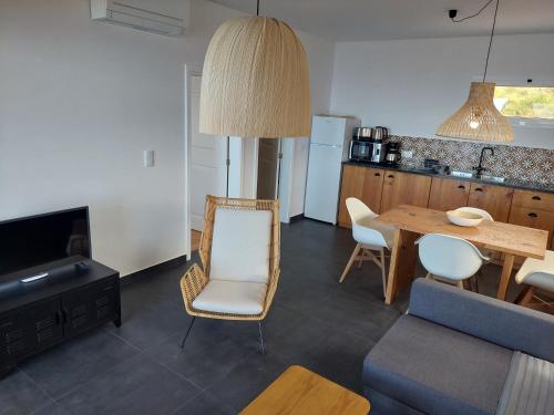 a kitchen and a living room with a table and chairs at Casa Caipirinha in Prazeres