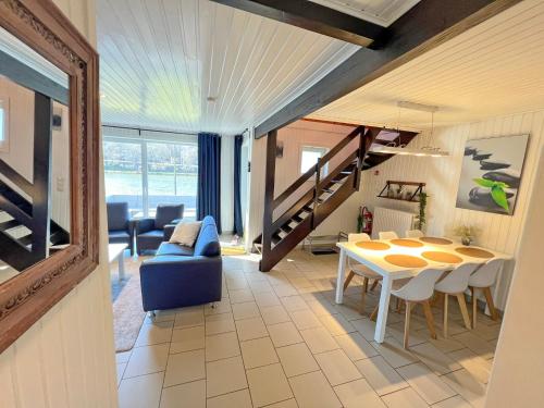 a living room with a table and a dining room at Lakeview Vielsalm in Vielsalm