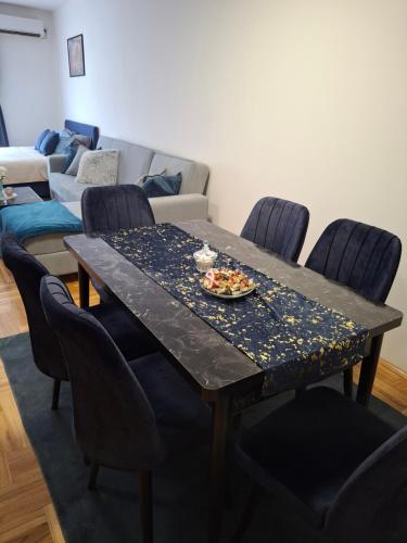 a table with a plate of food on top of it at Apartman Taurus in Požarevac