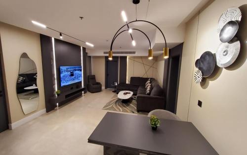 a living room with a couch and a table and a tv at Casablanca Elite in Jeddah
