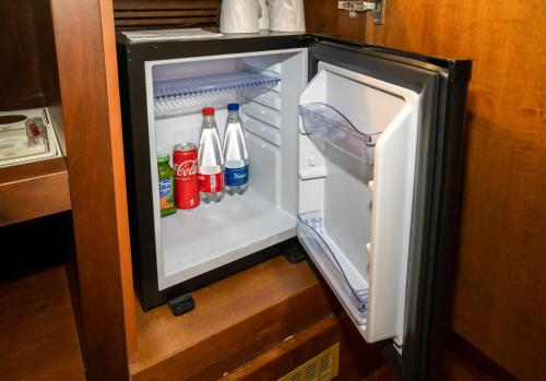 an open refrigerator with soda and drinks in it at Grand Hotel Duca D'Este in Tivoli Terme