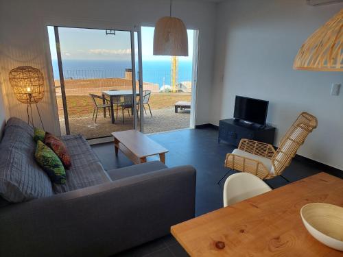 a living room with a couch and a table at Casa Caipirinha in Prazeres