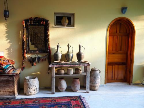 a room with vases on a table next to a door at Emel Pension in Guzelcamlı
