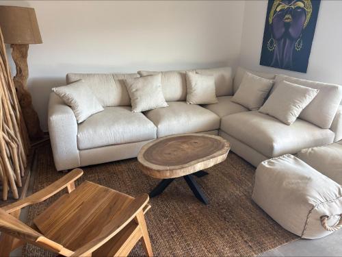 a living room with a couch and a coffee table at A Isula Paradisu - Classé 4 étoiles in LʼÎle-Rousse