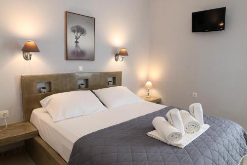 a bedroom with a large bed with white pillows at Niriides rooms in Kionia