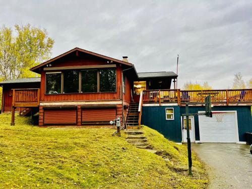 a house with a deck on the side of it at Alaska Getaway in Palmer